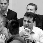 An injured leader of the Social Democrats Zoran Zaev is escorted out of the parliament in Skopje