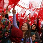 Supporters of Turkish President Tayyip Erdogan wave Turkey's national flags as they wait for the start of a rally for the upcoming referendum in the Kurdish-dominated southeastern city of Diyarbakir