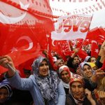 Supporters of Turkish President Tayyip Erdogan wave Turkey's national flags as they wait for the start of a rally for the upcoming referendum in the Kurdish-dominated southeastern city of Diyarbakir