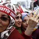 Supporters of Turkish President Tayyip Erdogan take a selfie as they wait for the start of a rally for the upcoming referendum in the Kurdish-dominated southeastern city of Diyarbakir