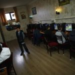 People use computers at an internet cafe in Ankara