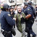 A demonstrator against U.S. President Donald Trump is detained during a Patriots Day Free Speech Rally in Berkeley, California