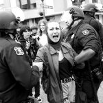 A demonstrator against U.S. President Donald Trump is detained during a Patriots Day Free Speech Rally in Berkeley, California