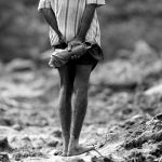 A man looks at the landslide site during a rescue mission in Athwelthota village, in Kalutara