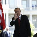 Turkey's President Erdogan waves as he arrives at the entrance to the West Wing to meet with President Trump at the White House in Washington