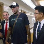 Former U.S. basketball star Dennis Rodman (C) arrives at Pyongyang's international airport, North Korea