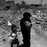 Displaced Iraqi residents flee their homes due to fighting between Iraqi forces and Islamic State militants near the Old City in western Mosul