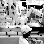 Staff program a robot arm by Nachi Robotic Systems at the International Robot Exhibition in Tokyo