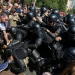 Anti-LGBT protesters clash with riot police during the equality march in Kiev