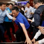 Ruling Democratic Progressive Party (DPP) legislator Chao Tien-lin scuffles with opposition Kuomintang (KMT) legislators during budget meeting for the infrastructure development program, at the Legislative Yuan