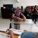 A woman casts her ballot during Turkey's presidential and parliamentary elections at a polling station in Yalova