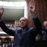 Turkish President Erdogan greets members of his ruling AKP during a meeting at the parliament in Ankara