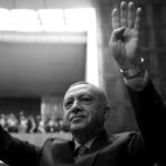 Turkish President Erdogan greets members of his ruling AKP during a meeting at the parliament in Ankara