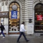 Pedestrians walk past a retail shop advertising a sale in Istanbul