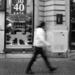 Pedestrians walk past a retail shop advertising a sale in Istanbul