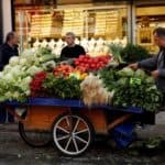FILE PHOTO: A street vendor stands next to his stall in front of a jewellery shop in Istanbul