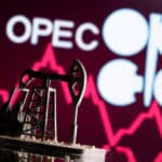 FILE PHOTO: A 3D printed oil pump jack is seen in front of displayed stock graph and Opec logo in this illustration picture
