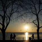 People walk along a park during the sunset in Istanbul