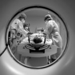 FILE PHOTO: Members of the medical staff in protective suits treat a patient suffering from the coronavirus disease (COVID-19) with a computer tomograph in the Intensive Care Unit (ICU) at Havelhoehe community hospital in Berlin