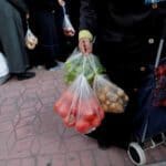 FILE PHOTO: People wait in line to buy vegetables sold in a tent set up by the municipality in Bayrampasa district of Istanbul