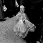 FILE PHOTO: People wait in line to buy vegetables sold in a tent set up by the municipality in Bayrampasa district of Istanbul