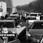 People wait in a traffic jam as they leave the city of Kharkiv