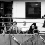 Police officers guard four detainees on the fishing boat “AKT-1”, in the island of Gran Canaria