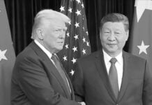 Trump and Xi Jinping shake hands at a formal meeting with flags in the background.