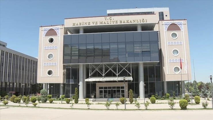 Front view of a Turkish government ministry building with a glass façade and a central entrance canopy.