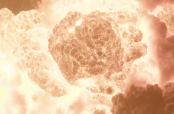Massive fiery explosion forming a large mushroom cloud above a desolate landscape at dusk.
