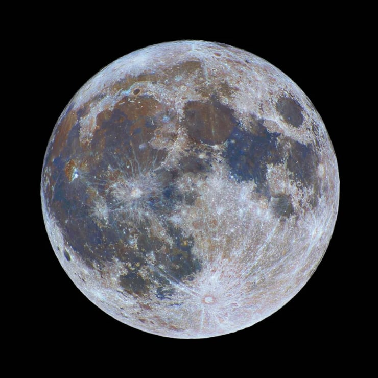 Close-up view of the Moon's cratered surface with dark maria and bright highlands against black space.