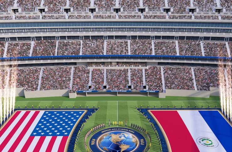 Aerial view of a football stadium with two huge national flags on the field—USA on the left and Paraguay on the right—and a globe emblem at the center, surrounded by spectators.