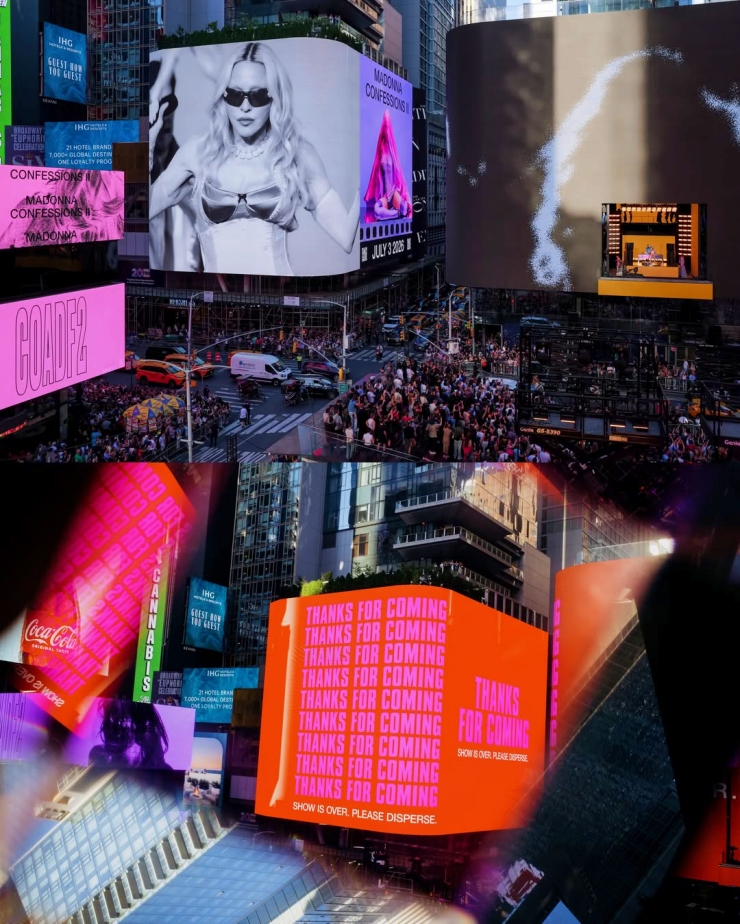 Busy Times Square with giant digital billboards, neon pink and orange ads, and a crowd below.