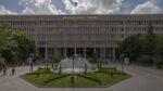 Facade of Ankara Adalet Sarayı (courthouse) with a central fountain and landscaped roundabout in front.