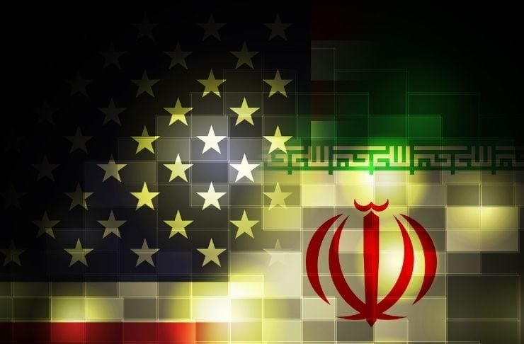 Composite image merging the United States flag and the Iranian flag with a grid of glowing squares, symbolizing US–Iran relations.