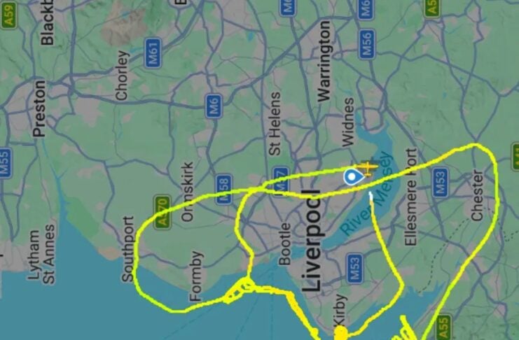 Map showing a bright yellow hand-drawn cycling route looping around Liverpool and coastal towns like Formby, tracing along the Mersey coast and Wirral peninsula.
