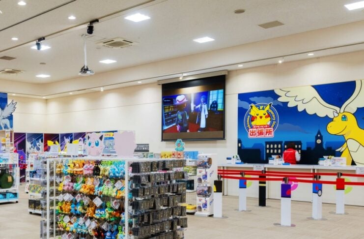 Interior of a bright toy store with racks of plush toys and accessories in the foreground; check-in counters and a large wall mural of a yellow dragon in the background.