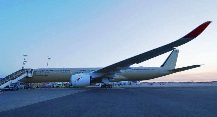Qantas Airbus A380-800 parked at the gate with a jet bridge connected for boarding.