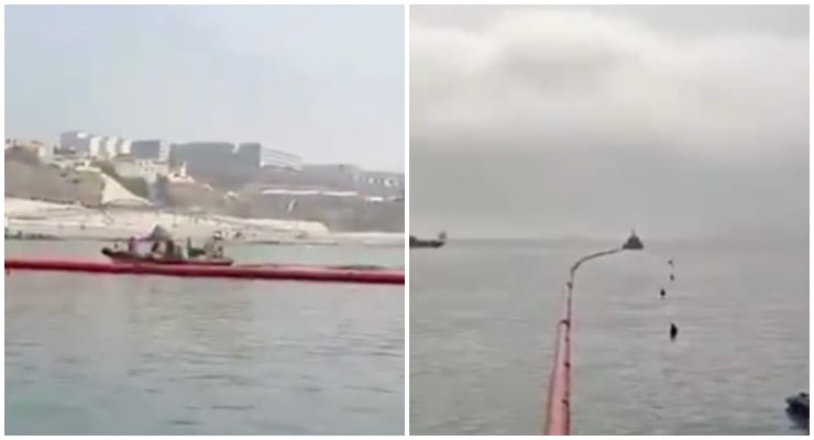 Two-panel shot of a red oil‑spill containment boom on calm water; left shows a work boat near the shoreline, right shows the boom extending farther into the sea.